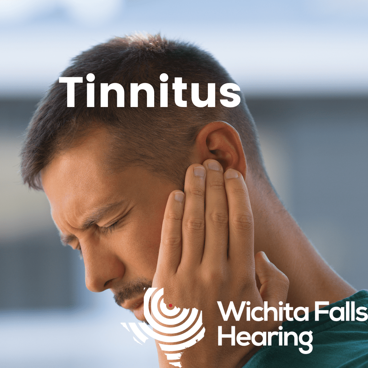 Man holding his ear with a pained expression, indicating ear discomfort or tinnitus