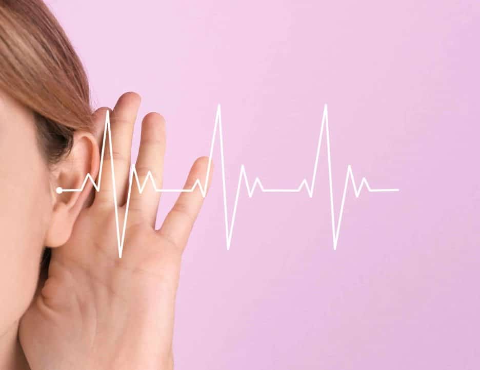 White sound waves entering a woman’s ear against a pink background.
