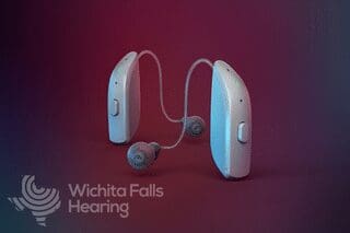 Hearing aids on red background with company logo