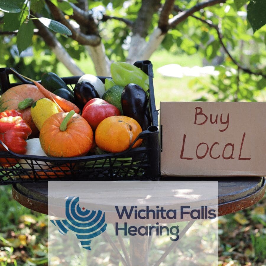 A basket of fruit and a sign that says buy local.